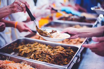 The hands of the poor have been begging to donate food from the donor, The concept of feeding