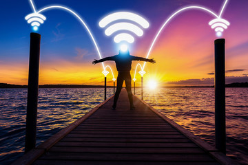 Obraz premium happy and relax woman, female, on wood bridge over sea with phone signal technology with network connection concept of happy nature life