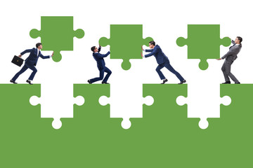 Businessman in teamwork concept with jigsaw puzzle