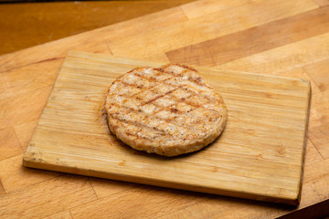 Meat cutlet for burger on a blackboard