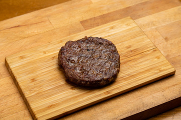Meat cutlet for burger on a blackboard