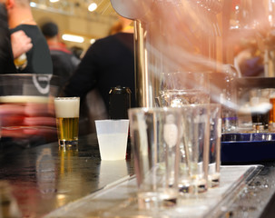 confusion and movement of glasses and customers at  brewery