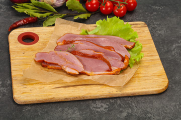 Sliced smoked duck breast served salad