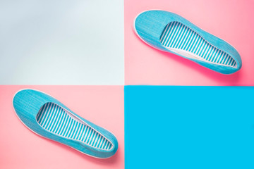 Casual summer footwear on pink and blue background. Women or teenage fashion, blue slipons. Urban...
