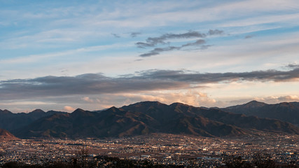Fototapeta na wymiar Kofu city in the evening surrounded by mountains