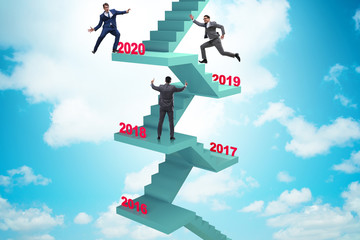 Businessman climbing stairs on yearly basis