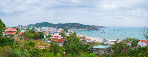 Naklejka premium Xuong Ly fishermen village on turquoise water coastline, awesome bay near Quy Nhon, Vietnam central coast travel destination, expansive view