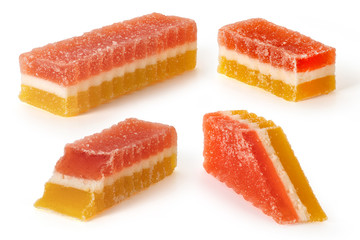Four marmalade fruit candies on white background
