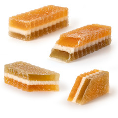 Four marmalade fruit candies on white background