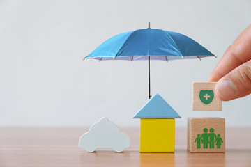 Insurance and investment concept of health, life, accident and travel. Hand picked wooden block...