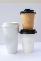 Paper cups with caps on grey background. Mock up.