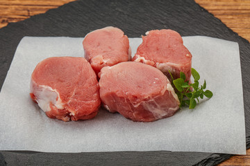 Raw pork medallion served rosemary
