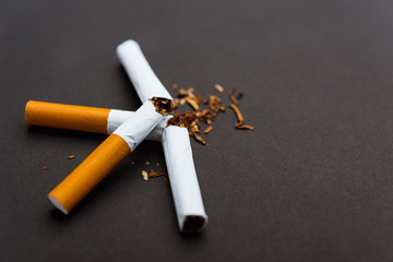 broken pile cigarette or tobacco on black background
