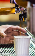 Espresso Machine pouring fresh coffee into cups at Local Coffee Shop..