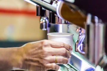 Espresso Machine pouring fresh coffee into cups at Local Coffee Shop..
