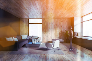 African woman in gray and wooden living room