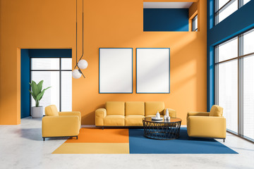 Orange and blue living room with poster gallery