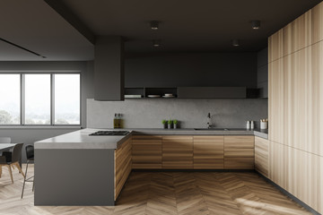 Fototapeta na wymiar Gray and wood kitchen with bar, side view