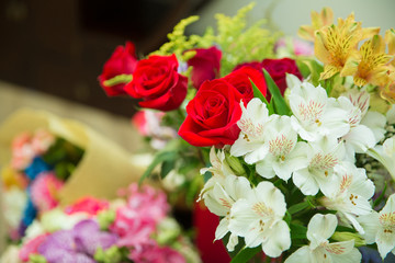 Valentines Day background, wedding day. Blooming red roses flower over blured hexagon bokeh background.