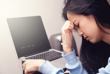 An asian woman getting anxiety and depression after checking stock market news about global...