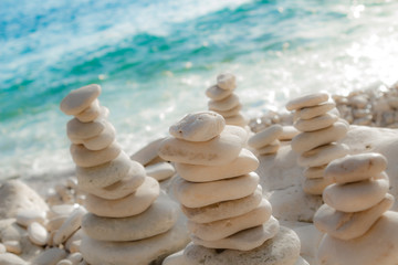 Fototapeta na wymiar Zen stones on the beach - summertime and good vibes.