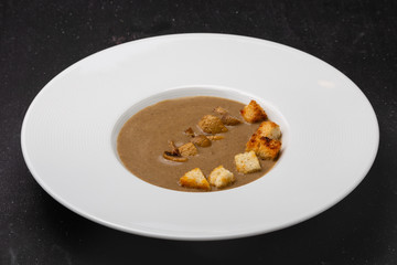 Soup in a plate for lunch in a restaurant