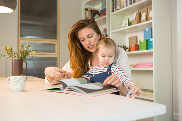 Mother mother reading book to her toddler