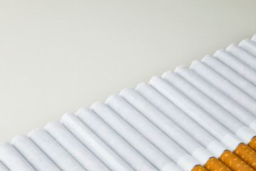 Long row of cigarettes with orange filter tips