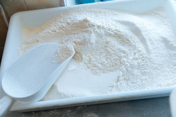 Kitchen, plastic transparent box with flour. Ingredient for cooking