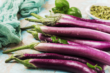 top view of fresh purple japanese eggplants on rustic wooden background