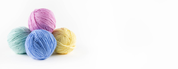 Multi-colored balls of yarn for knitting. Place for text.