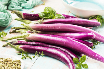 top view of fresh purple japanese eggplants on rustic wooden background