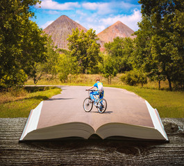 Boy with bicycle on a book - 349783827