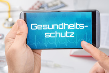Smartphone mit dem Text Gesundheitsschutz auf dem Display