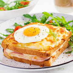 Breakfast.  Hot sandwich. Croque madame sandwich and a cup of latte macchiato coffee on the table. French cuisine. Copy space