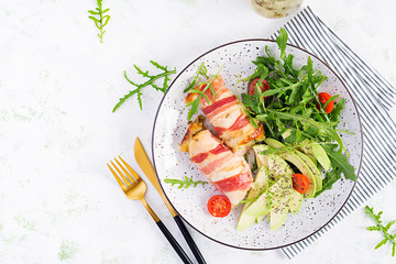 Ketogenic diet. Dinner dish with chicken meat roll wish  bacon, avocado, tomatoes and arugula....