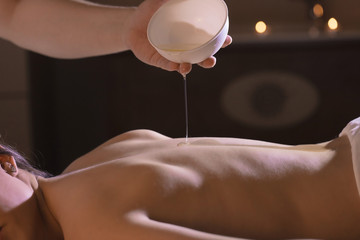 Wellness back massage with coconut oil for a beautiful girl and body treatments
