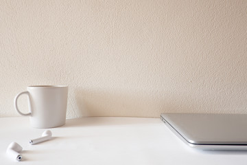 Front view  of white office desk table with the office equipments, computer keyboard and other office supplies on the modern space, flat lay.
