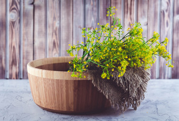 A bouquet of wild yellow St. John's wort flowers collected in the summer on a meadow for the...