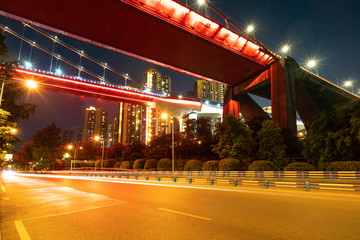 Red suspension bridges and highways at night