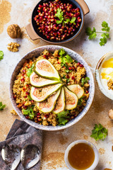 close-up view of tasty healthy couscous salat with figs fruits, nuts and pomegranate seeds