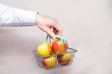 Juicy, natural, apples in a man’s hand. Gray background and copy space