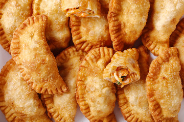 deep fried empanadas on a white paper