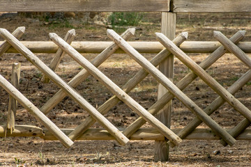 Fototapeta na wymiar Wooden stick fence with geometric structure