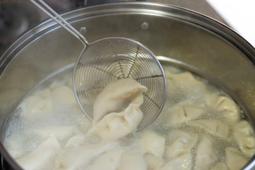 A pot of cooking dumplings