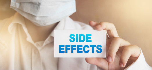 Doctor holding a card with Side Effects, medical concept