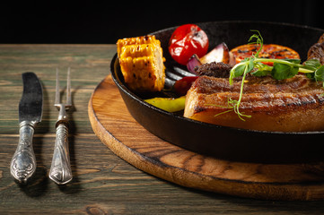 Fried meat in a pan with vegetables bbq.