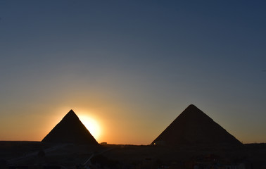 beauty  sunset background of pyramids giza  CAIRO EGYPT.Silhouette pyramids when sunset and orange sky