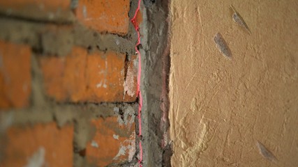 Repair, expose the laser level on the wall. Level the walls with a laser level. Installation of new tiles on the wall using a laser level