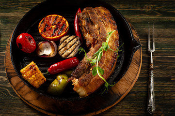 Fried meat in a pan with vegetables bbq.
